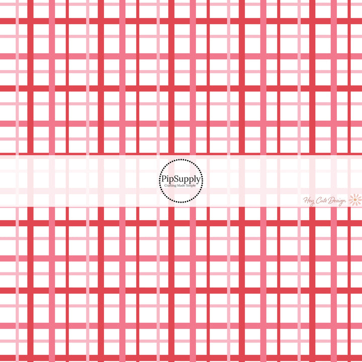 This holiday fabric by the yard features red and pink gingham pattern. This festive pattern fabric can be used for all your sewing and crafting needs!