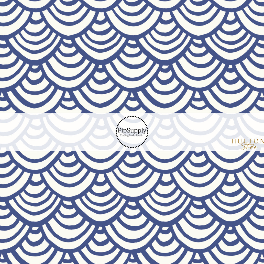 This summer fabric by the yard features blue and white scallop patterns. This fun themed fabric can be used for all your sewing and crafting needs!