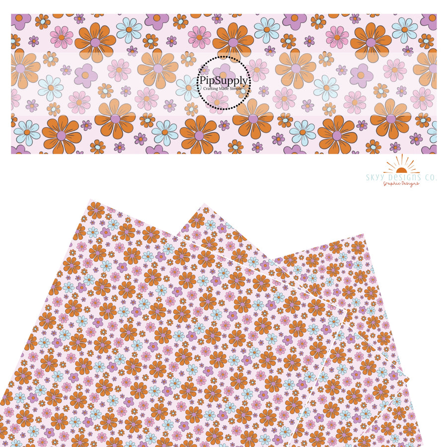 These Halloween flower themed pink faux leather sheets contain the following design elements: small and large bright daisies in pink, purple, light blue, and orange on pastel pink. Our CPSIA compliant faux leather sheets or rolls can be used for all types of crafting projects.