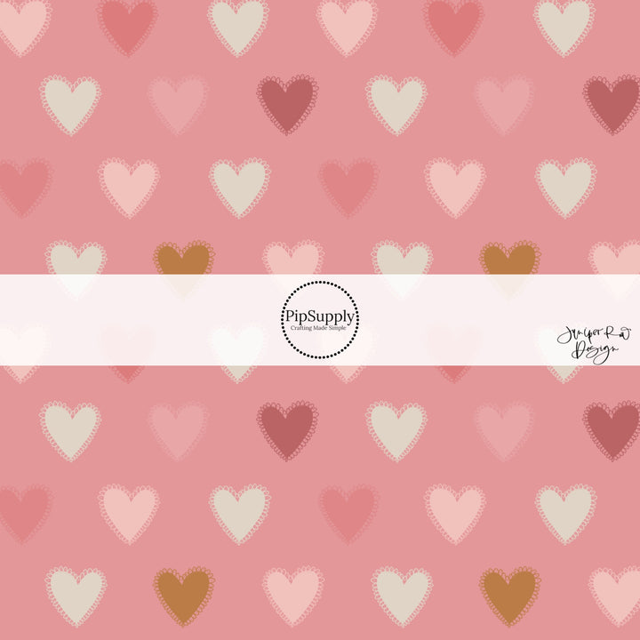 This holiday fabric by the yard features neutral color hearts on pink. This festive pattern fabric can be used for all your sewing and crafting needs!