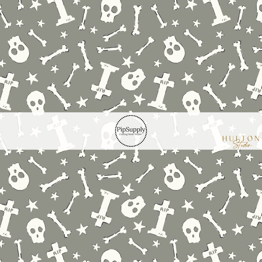 These Halloween themed pattern fabric by the yard features the following design elements: cream skulls and bones on gray. This fun spooky themed fabric can be used for all your sewing and crafting needs!