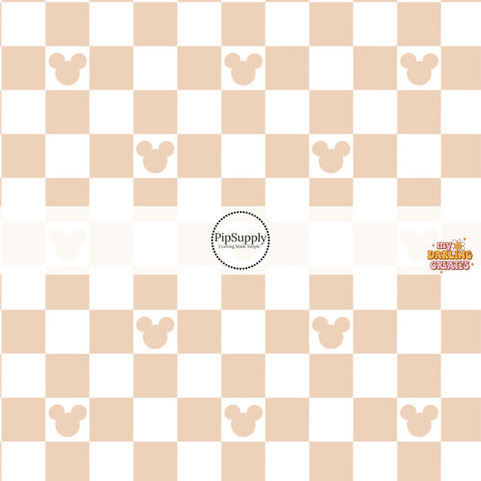 This magical inspired fabric by the yard features the following design: nude and cream checker pattern with mouse ears. This fun themed fabric can be used for all your sewing and crafting needs!