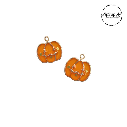 Gold spooky face and stars on orange pumpkin charm embellishment