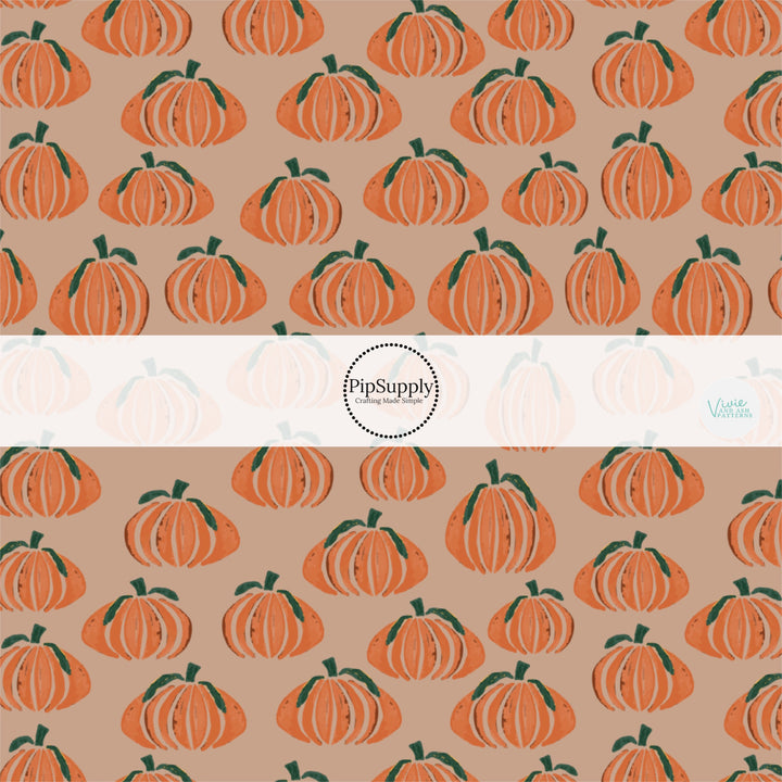 Multi sized orange pumpkins on taupe hair bow strips