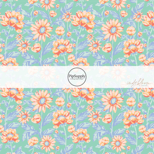 These pastel watercolor blooms on blue fabric by the yard features light pink, peach, and light blue beautiful flowers and leaves. 
