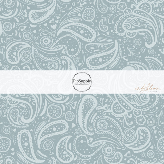 These western light blue fabric by the yard features light blue gray paisley pattern.