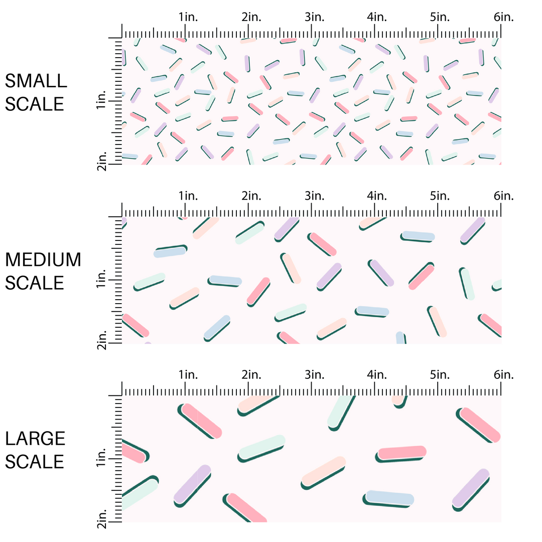 This small, medium, large scale chart of light pink, light purple, light blue, light orange, light red, light yellow sprinkles with a green shadow on white fabric by the yard.