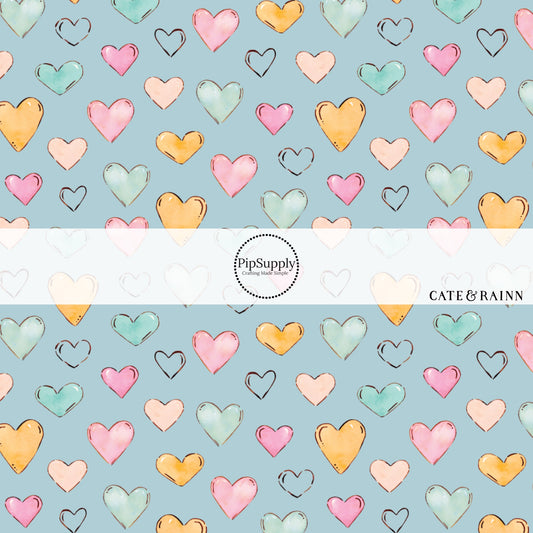 These heart themed blue fabric by the yard features light pink, orange, and blue watercolor hearts on baby blue. This fun summer heart themed fabric can be used for all your sewing and crafting needs! 