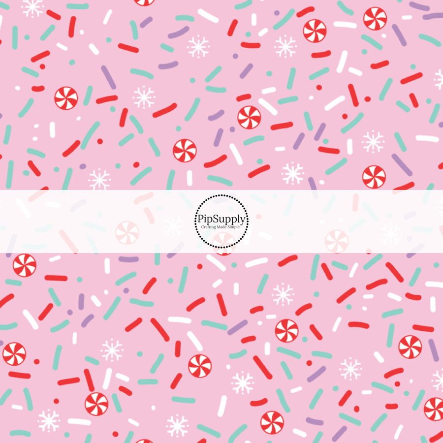 These Christmas themed pattern fabric by the yard features the following design elements: peppermint sprinkles on pink. This fun themed fabric can be used for all your sewing and crafting needs!