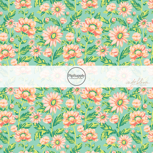 These pastel watercolor blooms on green fabric by the yard features light pink, peach, and light green beautiful flowers and leaves. 