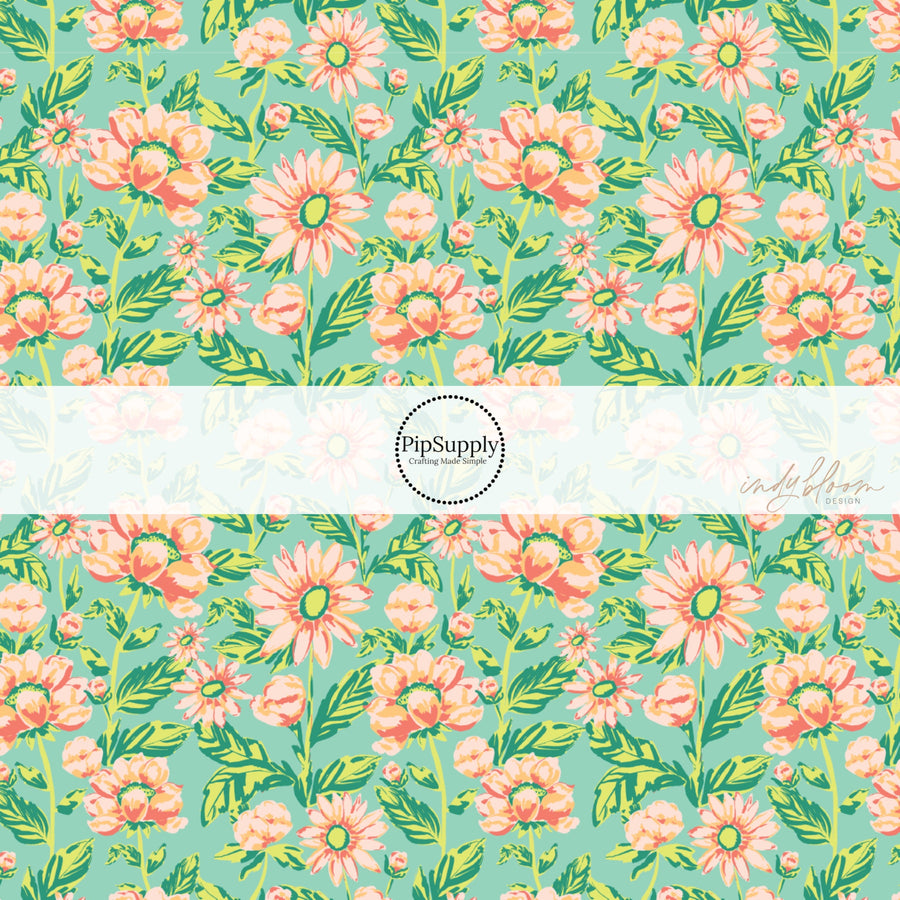 These pastel watercolor blooms on green fabric by the yard features light pink, peach, and light green beautiful flowers and leaves. 