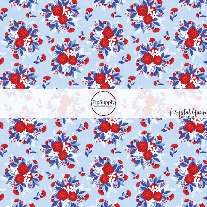 These red, white, and blue floral bouquets on light blue fabric by the yard features white, royal blue, and red beautiful flowers and leaves.