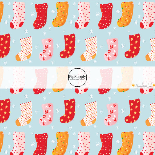 These Christmas themed pattern fabric by the yard features the following design elements: colorful Christmas stockings on blue. This fun themed fabric can be used for all your sewing and crafting needs!