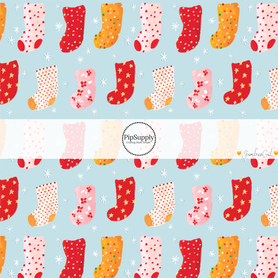 These Christmas themed pattern fabric by the yard features the following design elements: colorful Christmas stockings on blue. This fun themed fabric can be used for all your sewing and crafting needs!