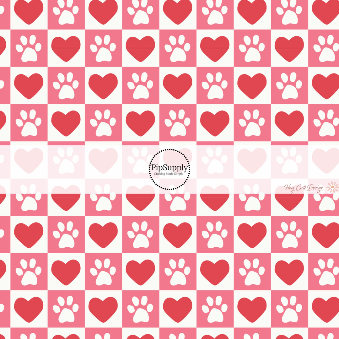 This holiday fabric by the yard features red hearts and dog paws on pink and cream checkers. This festive pattern fabric can be used for all your sewing and crafting needs!