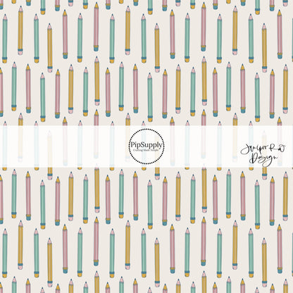 Lines of alternating multi pencils on cream bow strips