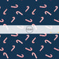 These Christmas themed pattern fabric by the yard features the following design elements: candy canes on navy. This fun themed fabric can be used for all your sewing and crafting needs!