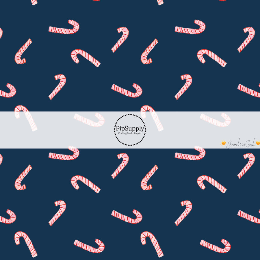 These Christmas themed pattern fabric by the yard features the following design elements: candy canes on navy. This fun themed fabric can be used for all your sewing and crafting needs!