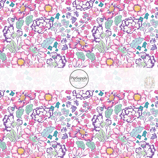 These floral themed white fabric by the yard features hot pink, purple, aqua, and light pink flowers on white. This fun summer floral themed fabric can be used for all your sewing and crafting needs! 