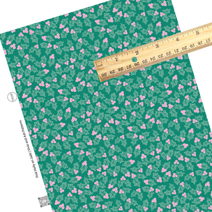 Groups of holly with pink berries on green faux leather sheets