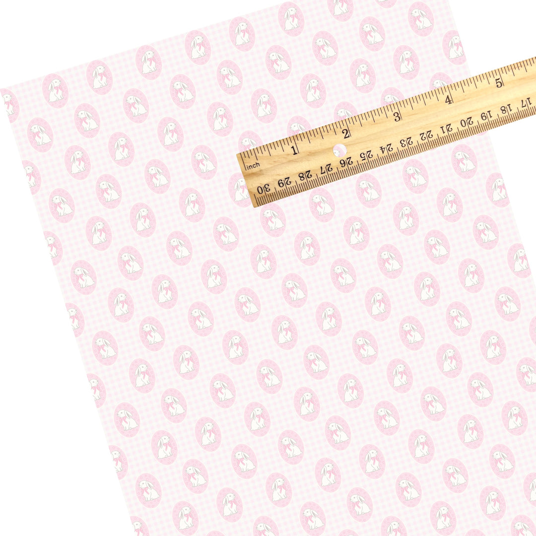 These Easter themed faux leather sheets contain the following design elements: Easter bunnies in pink circles on a light pink plaid pattern. Our CPSIA compliant faux leather sheets or rolls can be used for all types of crafting projects.