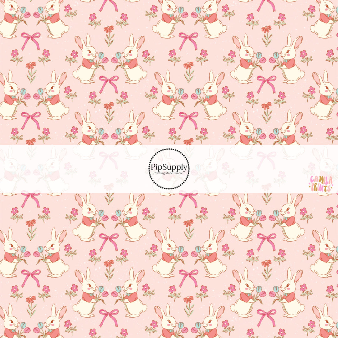 This Easter themed fabric by the yard features Easter bunnies and flowers on pink. This fun pattern fabric can be used for all your sewing and crafting needs!