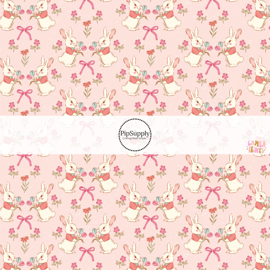 This Easter themed fabric by the yard features Easter bunnies and flowers on pink. This fun pattern fabric can be used for all your sewing and crafting needs!