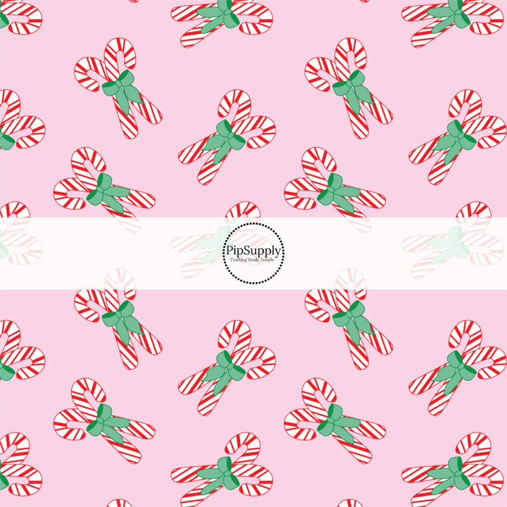 These Christmas themed pattern fabric by the yard features the following design elements: Christmas candy canes on pink. This fun themed fabric can be used for all your sewing and crafting needs!