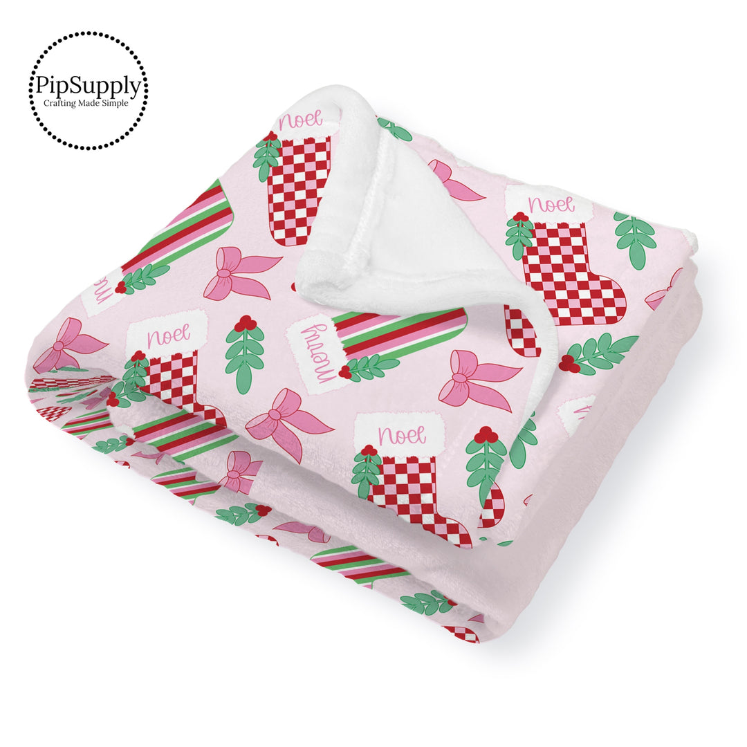 This Santa designer pattern is printed onto the front side of our soft touch minky blankets. The backside will not be printed and left the natural cream/white color of the blanket. This print pattern features Christmas stockings on pink.