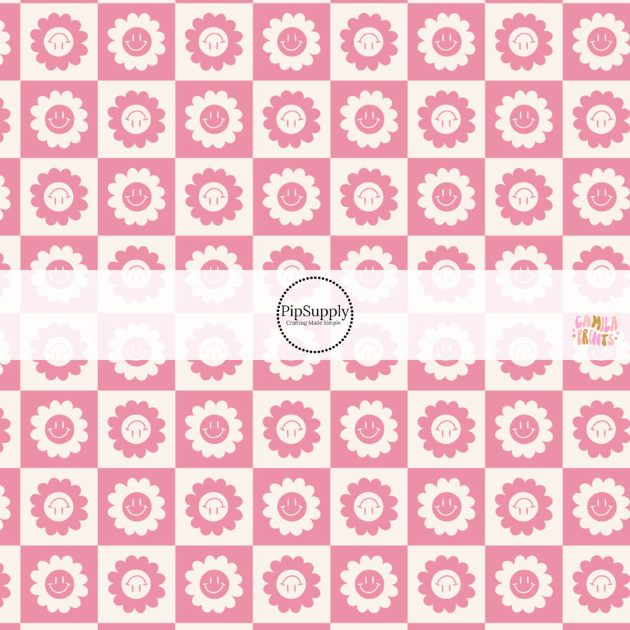 This spring fabric by the yard features smiley flowers on pink checkers. This fun pattern fabric can be used for all your sewing and crafting needs!