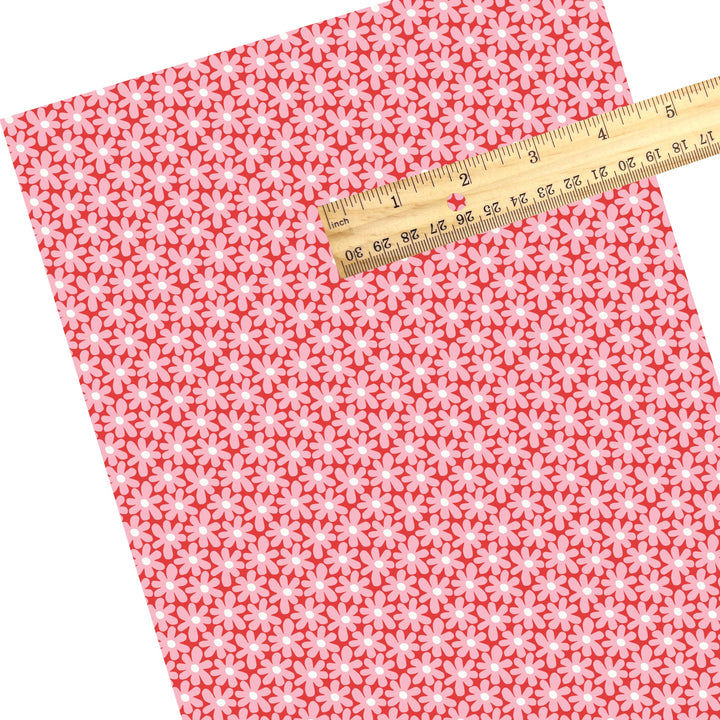 These holiday faux leather sheets contain the following design elements: pink daisies on red. Our CPSIA compliant faux leather sheets or rolls can be used for all types of crafting projects.