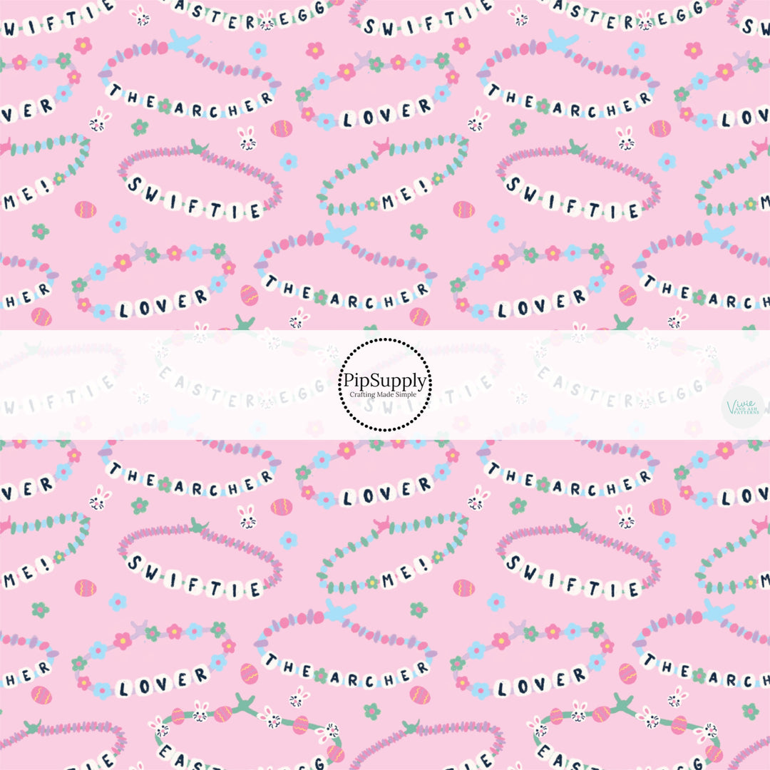 This Easter themed fabric by the yard features friendship bracelets on pink. This fun pattern fabric can be used for all your sewing and crafting needs!