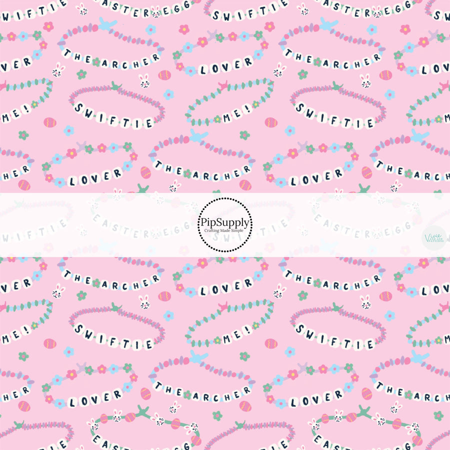 This Easter themed fabric by the yard features friendship bracelets on pink. This fun pattern fabric can be used for all your sewing and crafting needs!