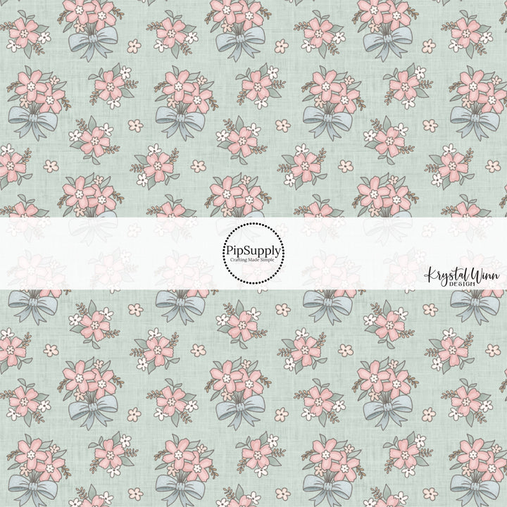 This fun fabric by the yard features pink flower bundles with blue bows. This fun pattern fabric can be used for all your sewing and crafting needs!