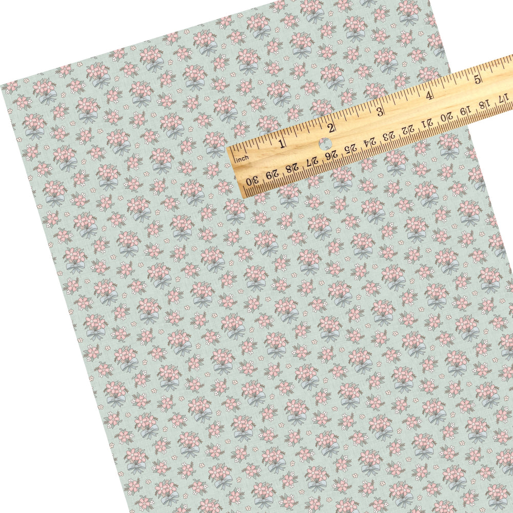 These floral themed faux leather sheets contain the following design elements: pink flower bundles with blue bows. Our CPSIA compliant faux leather sheets or rolls can be used for all types of crafting projects.