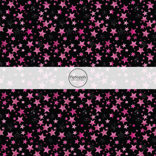 This holiday fabric by the yard features pink stars on black. This festive pattern fabric can be used for all your sewing and crafting needs!