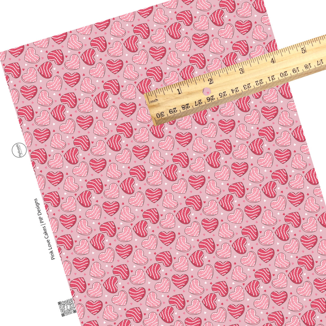 These Valentine's pattern themed faux leather sheets contain the following design elements: pink heart shaped cakes surrounded by tiny hearts on light pink. Our CPSIA compliant faux leather sheets or rolls can be used for all types of crafting projects.