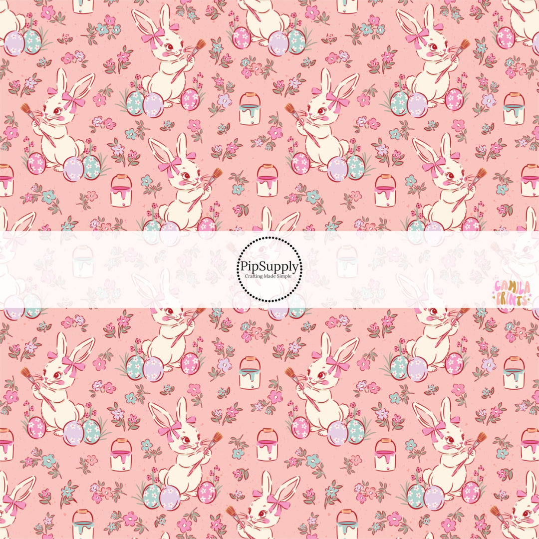 This Easter themed fabric by the yard features Easter bunnies painting Easter eggs on pink. This fun pattern fabric can be used for all your sewing and crafting needs!