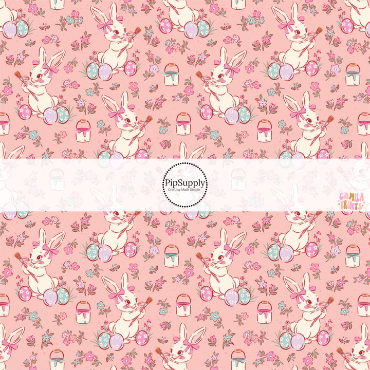 This Easter themed fabric by the yard features Easter bunnies painting Easter eggs on pink. This fun pattern fabric can be used for all your sewing and crafting needs!