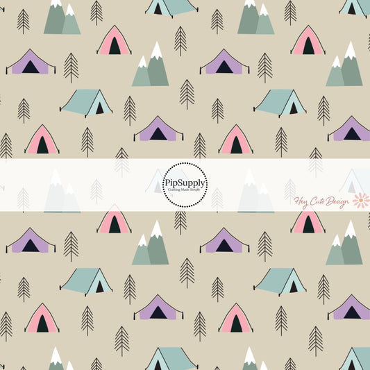 These camping outdoor light tan fabric by the yard features pine trees, mountains pink, purple, and blue tents on light tan. This fun camping themed fabric can be used for all your sewing and crafting needs! 