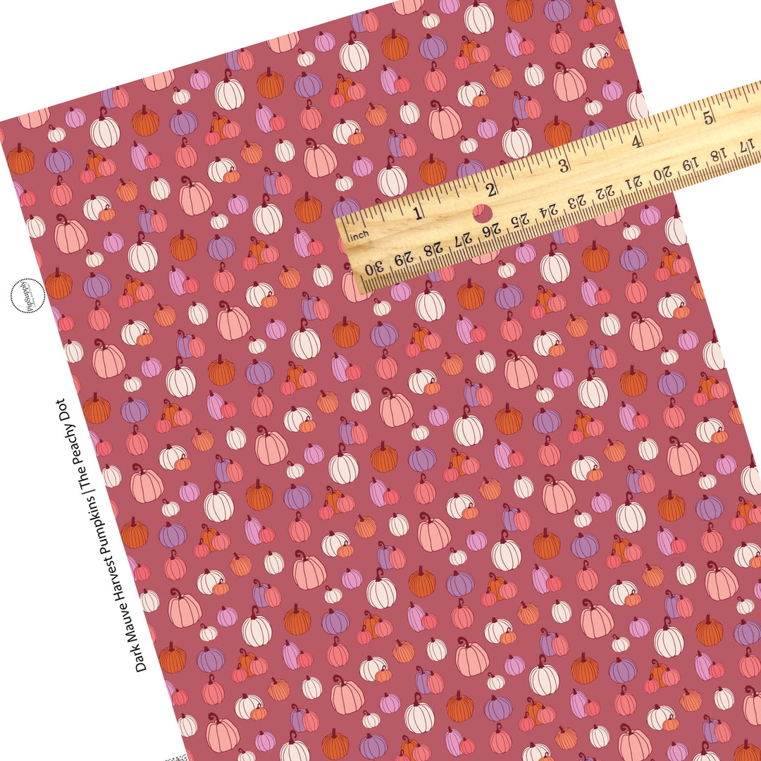 Multi pumpkins on mauve faux leather sheets