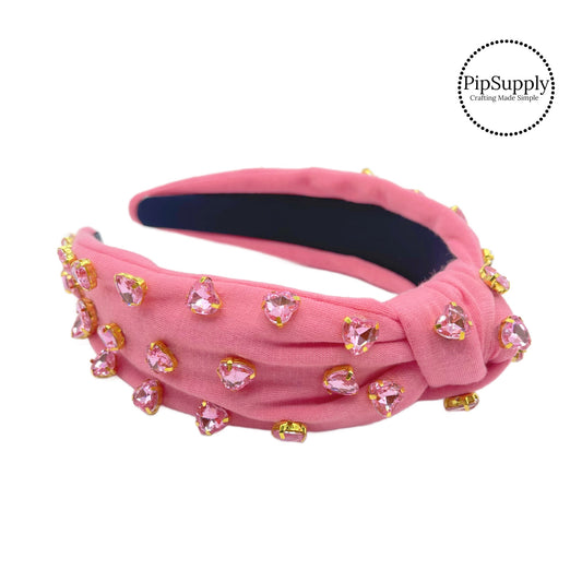 Pink rhinestone hearts on pink nylon knotted headband 