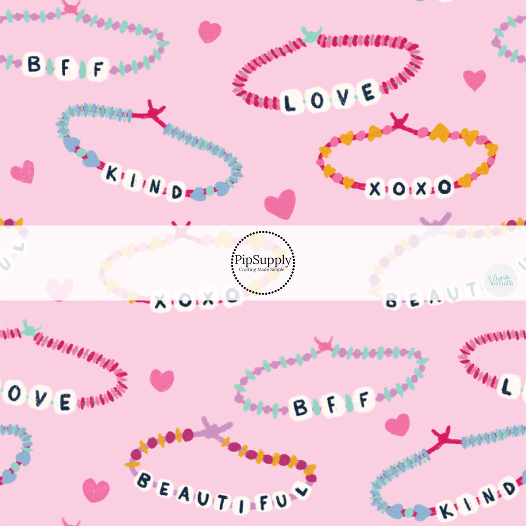 This Valentine's Day themed fabric by the yard features friendship bracelets on pink. This fun pattern fabric can be used for all your sewing and crafting needs!