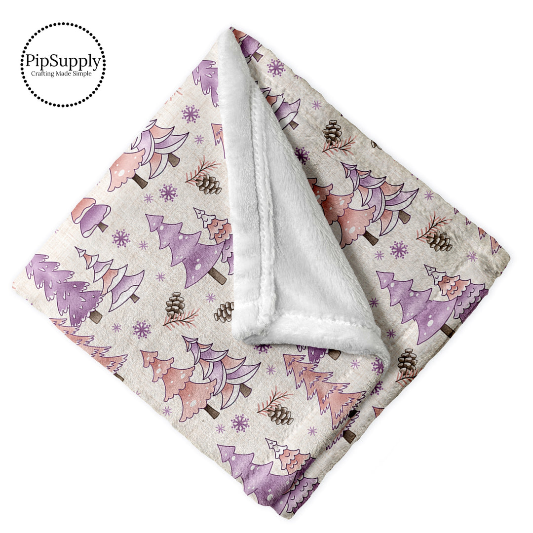 This winter designer pattern is printed onto the front side of our soft touch minky blankets. The backside will not be printed and left the natural cream/white color of the blanket. This print pattern features pink and purple winter trees.