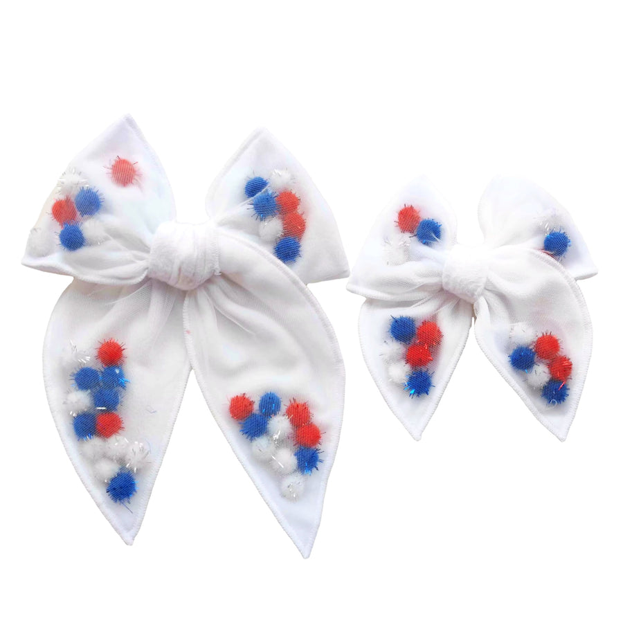 These patriotic pom pom shaker pre-cut tied bows are ready to package and resell to your customers no sewing or measuring necessary! These hair bows come with a clip already attached. The shaker bows come pre-filled with red, white, and blue pom poms.