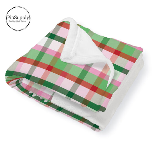 This winter designer pattern is printed onto the front side of our soft touch minky blankets. The backside will not be printed and left the natural cream/white color of the blanket. This print pattern features colorful Christmas gingham pattern.