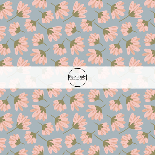 This summer fabric by the yard features pink wildflowers on blue. This fun summer themed fabric can be used for all your sewing and crafting needs!