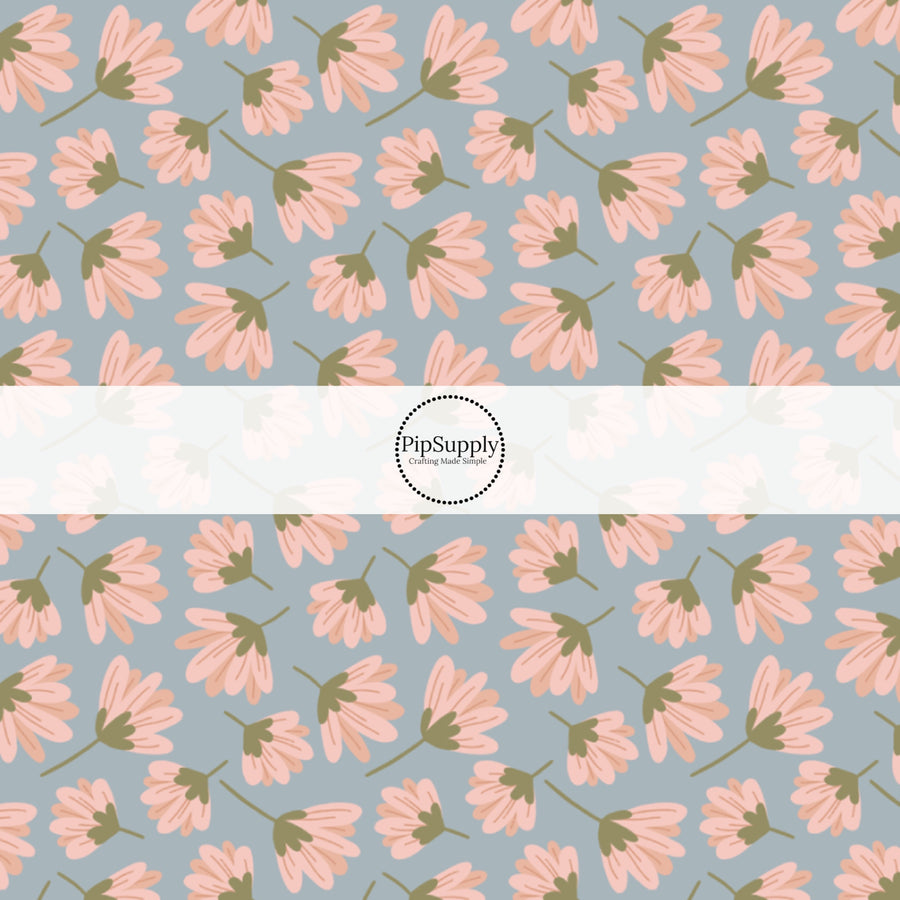 This summer fabric by the yard features pink wildflowers on blue. This fun summer themed fabric can be used for all your sewing and crafting needs!