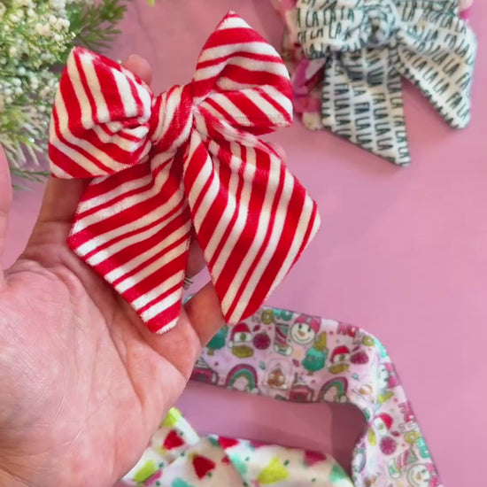 Each Christmas themed pack includes four untied, flat VELVET Ruth bows printed with the same pattern shown in the picture. The set of 4 hair bow strips are the same pattern and make two piggie sets. They will come untied and will need to be tied into a finished bow and attached to a clip or headband. Headbands and clips sold separately. Recommended clip size is 1.75” or 2.375” alligator metal or plastic clip.