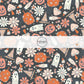 These Halloween themed black fabric by the yard features pumpkins, ghosts, mushrooms, and hats surrounded by small and large daisy flowers on black. This fun spooky themed fabric can be used for all your sewing and crafting needs! 